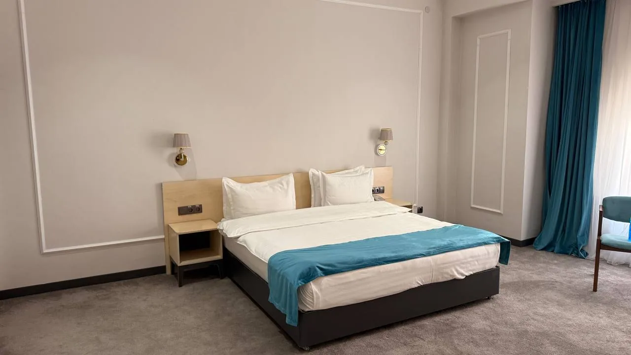 Suite bedroom with a King-size bed at Khiva Residence Hotel, Khiva